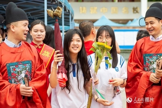 6月7日上午，在南寧市天桃實(shí)驗(yàn)學(xué)校翠竹校區(qū)，老師們?cè)跒榭忌鷤兗佑凸膭?！人民網(wǎng)記者 嚴(yán)立政攝