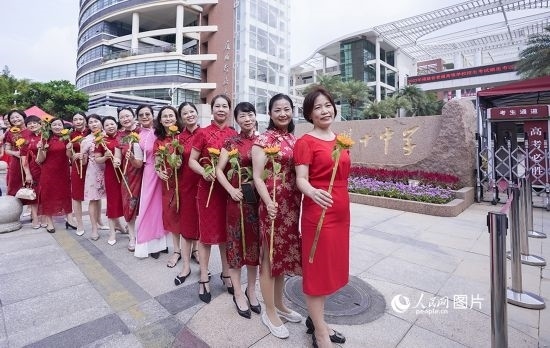 6月7日一早，廈門雙十中學(xué)考生家長們身穿旗袍，手拿向日葵在考場外為孩子加油打氣，寓意“旗開得勝，一舉奪魁”。人民網(wǎng)記者 陳博攝