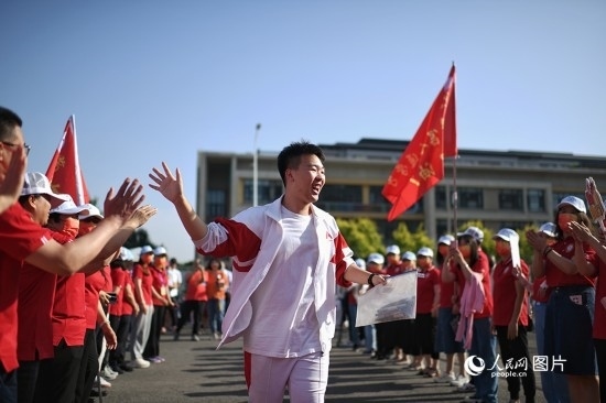 6月7日，在北京市人大附中通州校區(qū)考點(diǎn)，考生與送考老師擊掌加油。人民網(wǎng)記者 翁奇羽攝