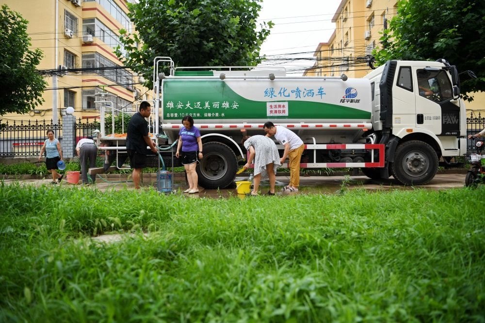 河北省涿州市新星小區(qū)居民從供水車?yán)锝铀?月4日攝）。新華社記者 牟宇 攝