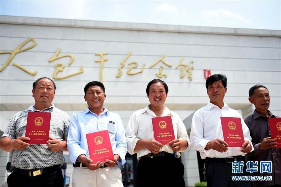鳳陽縣小崗村農(nóng)民展示領(lǐng)到的《農(nóng)村土地承包經(jīng)營權(quán)證》（2015年7月8日攝）。
