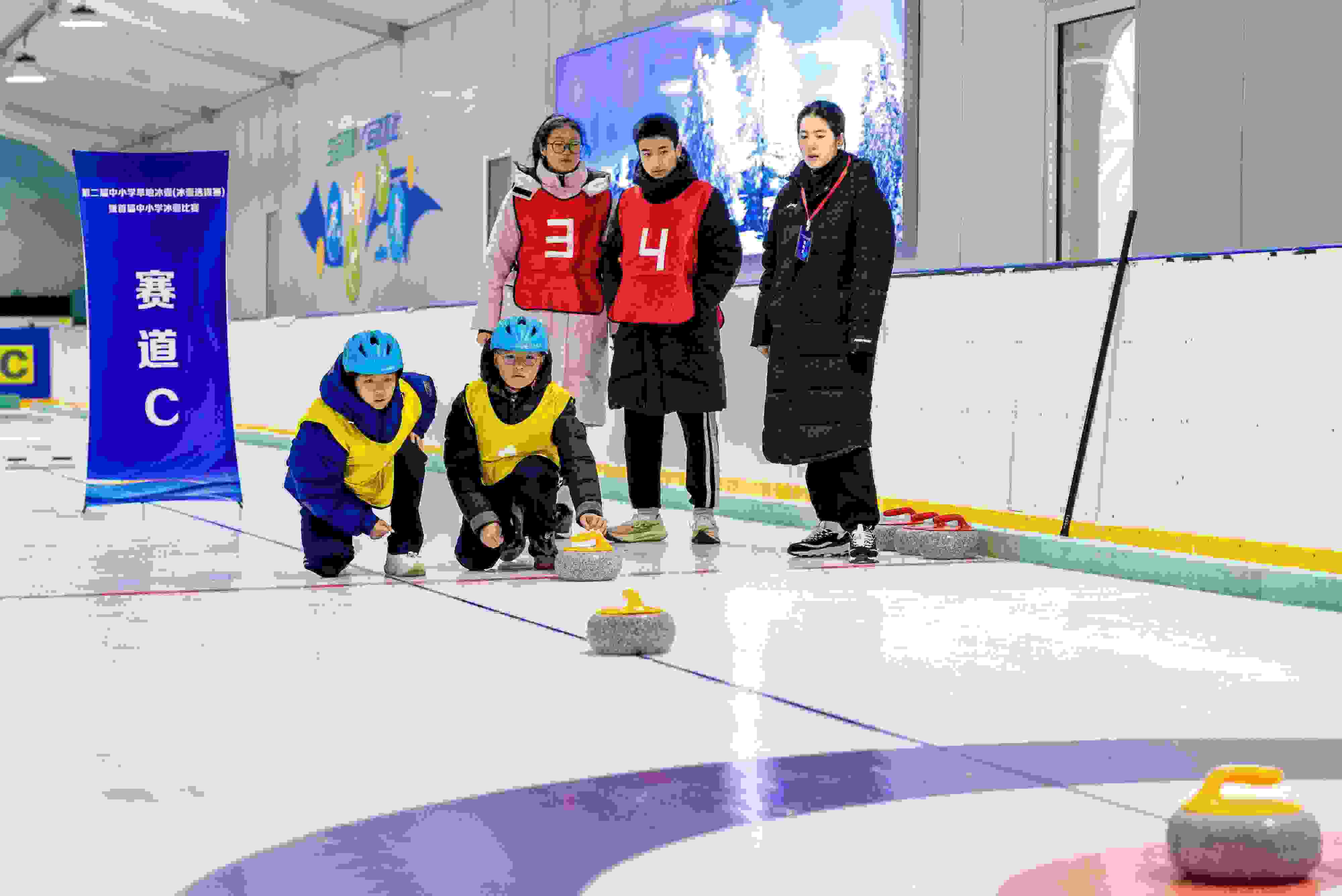 2023年12月10日，參賽選手在呼和浩特首屆中小學(xué)冰壺比賽中投擲冰壺。