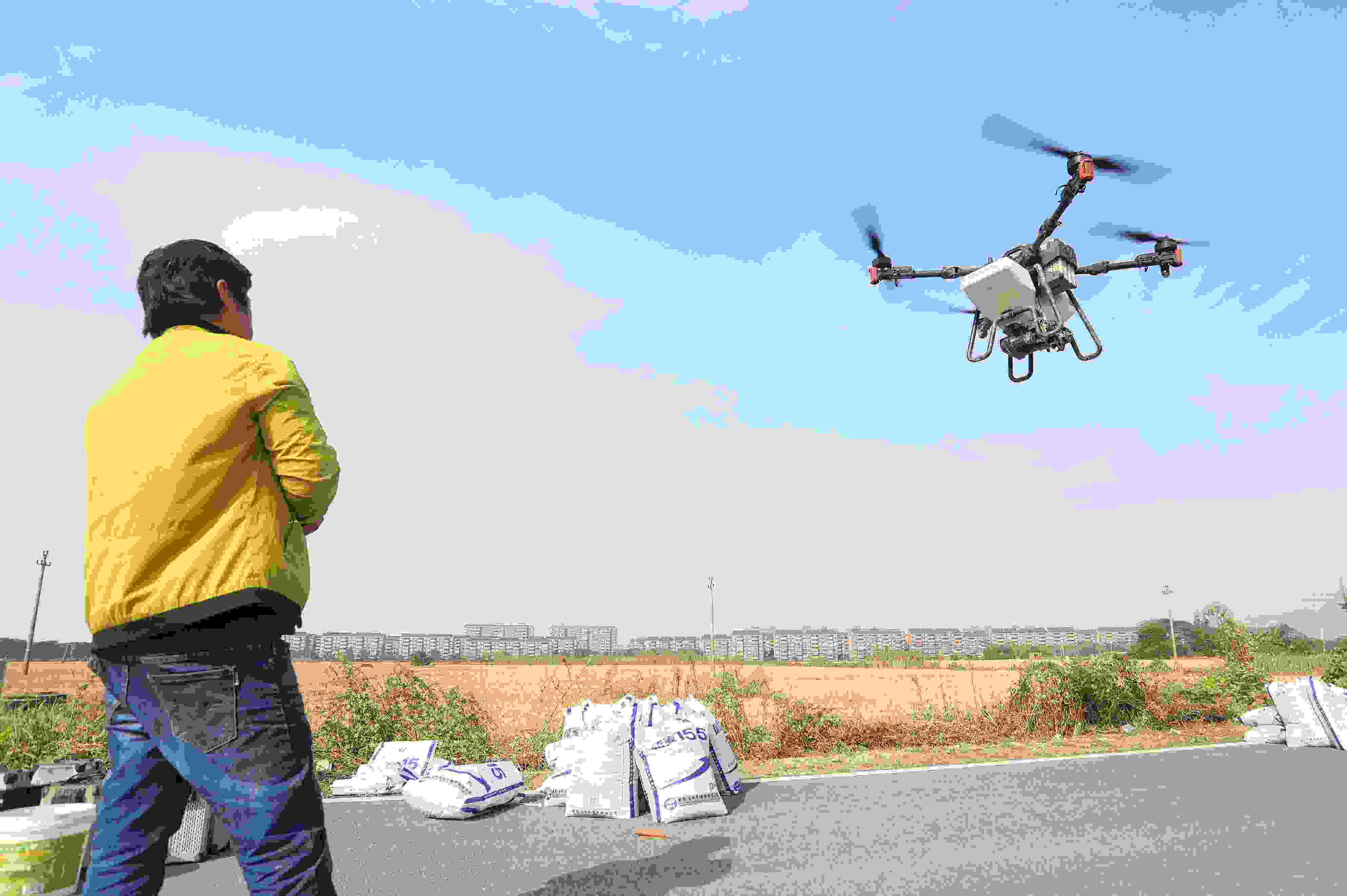 2023年11月15日，浙江嘉興，南湖區(qū)七星街道一處農(nóng)田里，農(nóng)民操縱無人機進行冬小麥飛播。