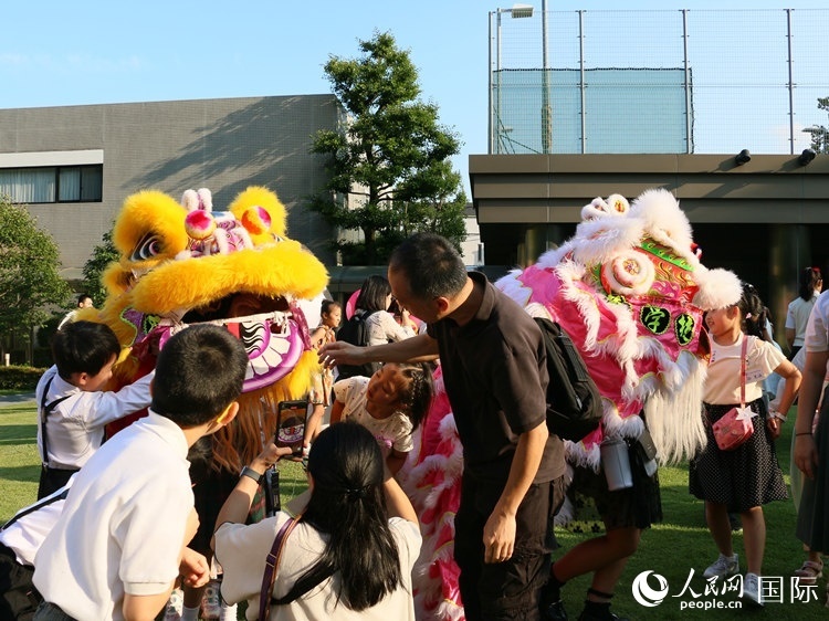 孩子們好奇地圍觀舞獅。人民網(wǎng) 許可攝