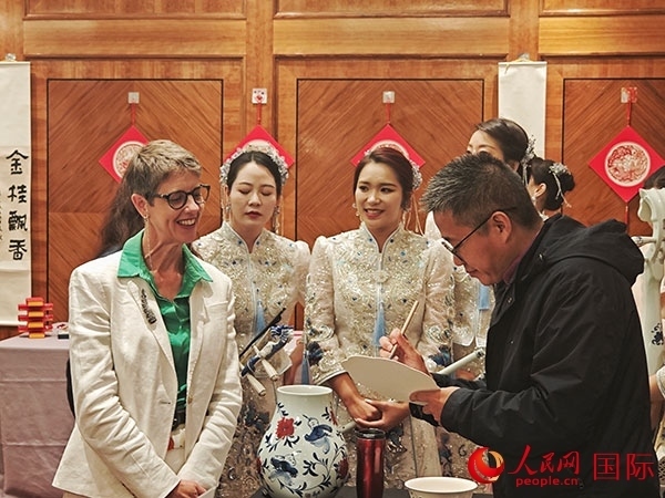 現(xiàn)場(chǎng)的非遺傳承人為英國(guó)觀眾展示畫技。人民網(wǎng)記者 邢雪攝