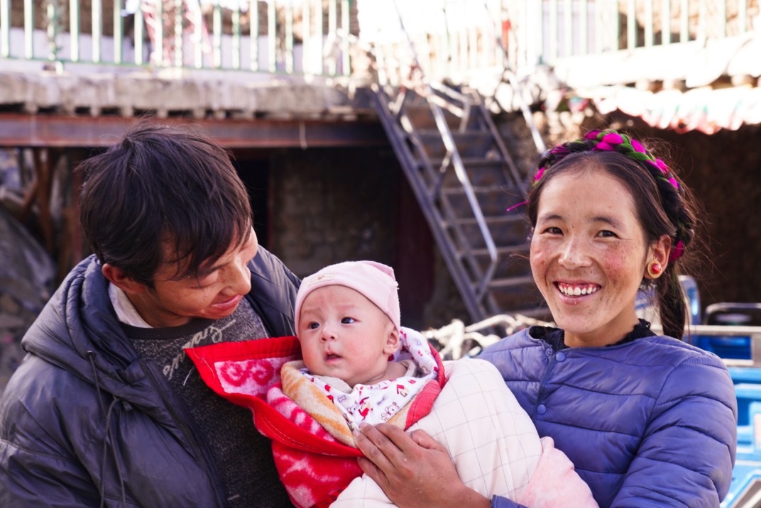 1月11日，在西藏日喀則市人民醫(yī)院，受災(zāi)群眾抱著自己在地震中受傷的孩子康復(fù)出院。人民日?qǐng)?bào)記者徐馭堯攝