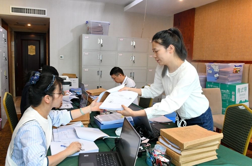 福州市委巡察機(jī)構(gòu)對全市法院系統(tǒng)開展提級聯(lián)動交叉巡察。在永泰縣駐地，巡察組工作人員查看財(cái)務(wù)憑證（2024年5月21日攝）。新華社記者 林善傳 攝